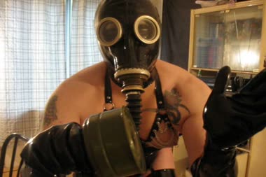 Fondling In Latex  Gas Mask - Transsexual fetish queen, vanessa fetish, fondling herself while wearing latex hood, gloves and stockings, with pvc corset and her russian gas mask